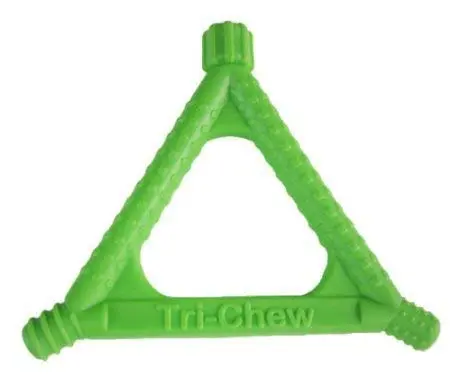 A green triangular chew toy is sitting on top of a table.