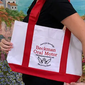 A woman holding a red and white bag