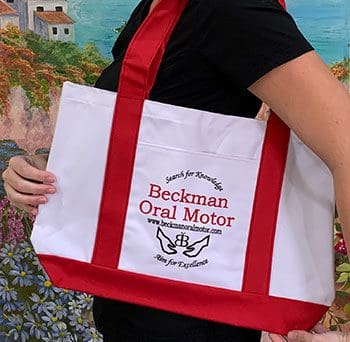 A woman holding a red and white bag